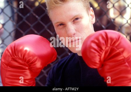 Young man wearing boxing gloves, portrait, close up Stock Photo