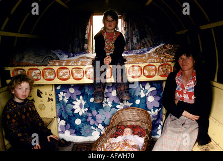 Irish Travellers gypsy family interior of painted decorated horse drawn bow topped caravan Ireland, mother, baby and sons 1970s 1979 Eire. HOMER SYKES Stock Photo