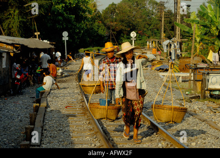Slums people living in poverty in a squatter camp the railway line outside Bangkok main train station walking into city to work Thailand 1990S 19991 Stock Photo