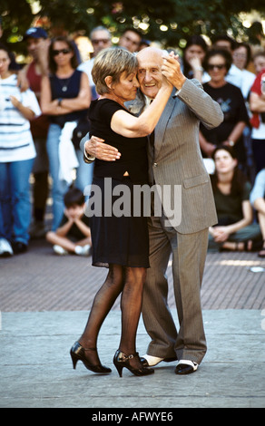 Older couple in love dancing cheek to cheek. Tango dancing in Plaza Dorrego, San Telmo Buenos Aires, Argentina. 2002 2000s HOMER SYKES Stock Photo