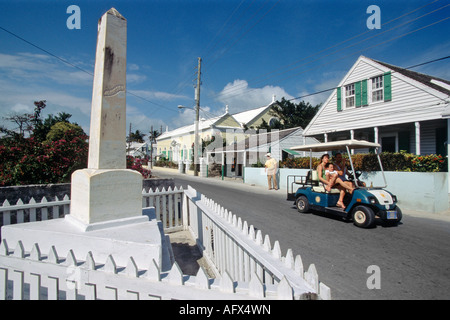 Street scene with memorial to Thomas W Johnson and golf cart the chief form of transportation in Harbour Island Bahamas Stock Photo