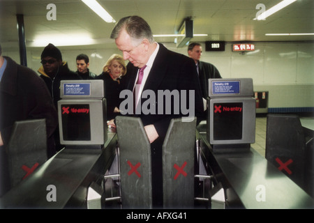 Steve Norris London mayoral elections candidate visiting London Underground trying to get the ticket barrier machine to work 2000s 2000 UK HOMER SYKES Stock Photo