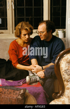 British director Anthony Minghella holding hands with actress Juliet Stevenson directing her. On film set of Truly Madly Deeply. London UK 1990s 1990 Stock Photo