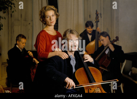 Alan Rickman British actor playing cello Juliet Stevenson British actress on film set of Truly Madly Deeply.  London, England  March 1990 1990s HOMER Stock Photo