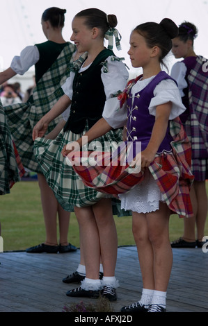 Girl wears galoshes over her dancing shoes Preparing for the judging of the best dressed dancer competition Stock Photo