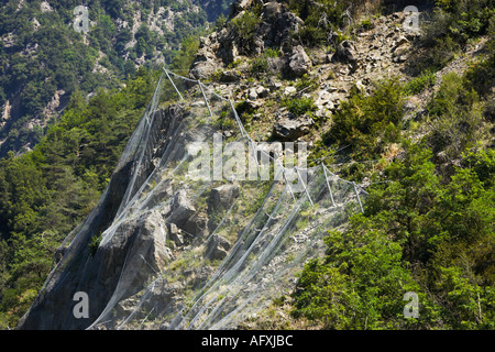 Wire netting to stop rocks falling Alpes Maritimes France Stock Photo