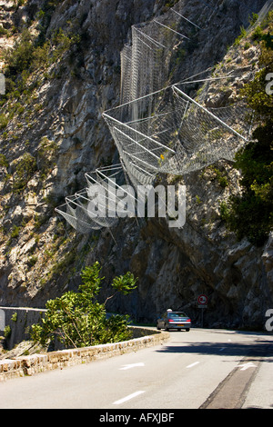 Wire netting used to stop rocks falling onto the road in the Alpes Maritimes, France Stock Photo