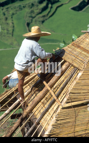 2000 year old Banaue rice terraces on Luzon,the Philippines are a UNESCO world heritage site,Ifugao tribesman roofs tribal home Stock Photo