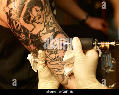 Tattoo artist designing new tattoo on arm, Reykjavik Iceland Stock Photo