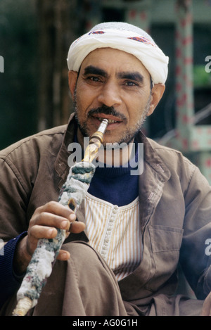 Egyptian man smoking Narguile in Khan El Khalil market cairo egypt Stock Photo