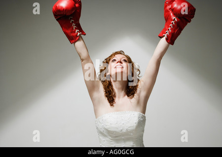 Portrait of confident young woman wearing red boxing gloves and black sports  bra Stock Photo