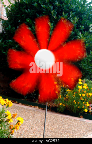 Red pinwheel spinning in garden Stock Photo