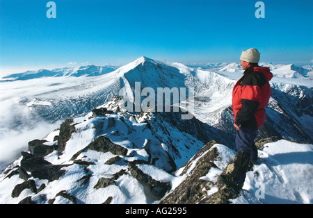 A man is looking at the highest peak of the Urals the Narodnaya Mount Russia Ural Stock Photo