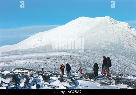 Group of tourists is mounting to the highest peak of the Urals the Narodnaya Mount Russia Stock Photo