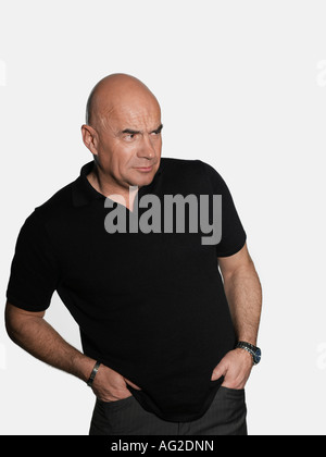 Middle-aged man standing with hands in pockets Stock Photo