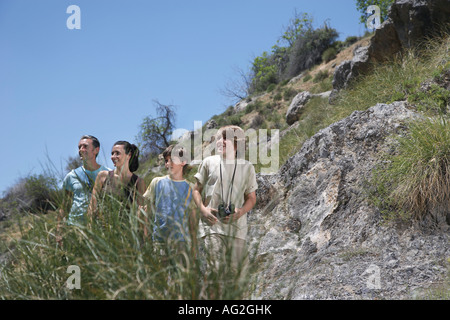Parents with two sons (7-12) in mountains Stock Photo
