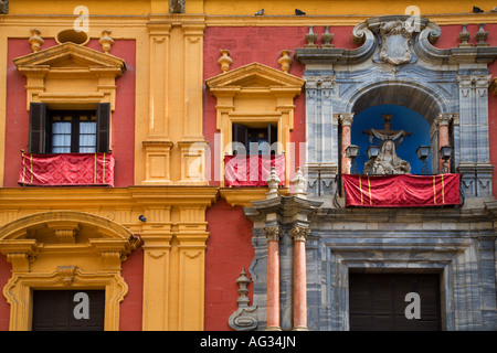 Detail of the Bishops Palace in Plaza del Obispo with the statue of La Virgen de las Angustias over the main portal Malaga Spain Stock Photo