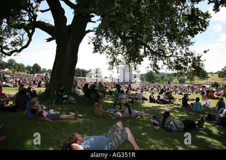 Festival go-ers relaxing in the summer sun under a tree by the Castle Stage at the Big Chill music Festival August 2007 Stock Photo