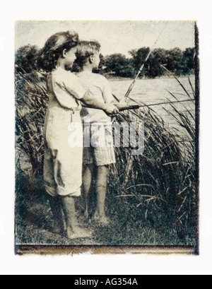 Black and white Polaroid transfer image of boy and girl fishing in lake Stock Photo