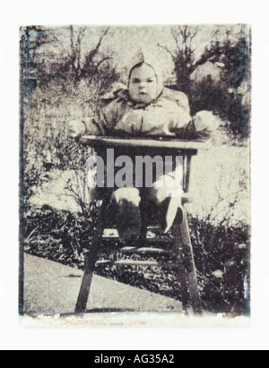 Polaroid transfer image of baby in high chair circa 1940s Stock Photo