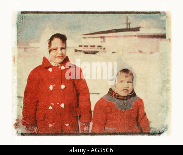 Polaroid transfer portrait of sisters in red parkas circa 1960s Stock Photo