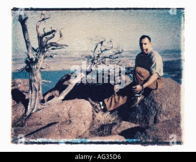 Polaroid transfer portrait of man on high scenic overlook circa 1960s Stock Photo
