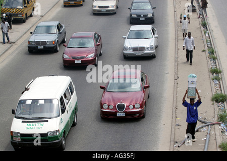 Cars and pedestrians on busy road, Lagos Nigeria, Africa. Stock Photo