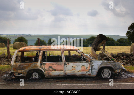 Stolen Volvo Estate burnt out and dumped on side of road in South Wales UK Stock Photo