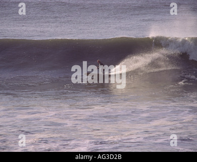 Surfer on longboard on a classic fast powerful big surf wave breaking at Saunton Point near Croyde Bay North Devon England Stock Photo