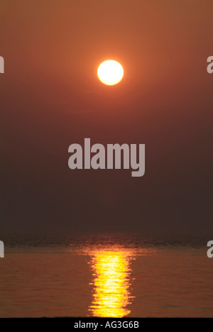 Sunset over water on Lake Michigan at Manistee Michigan beach Stock Photo