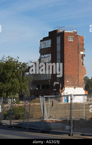 Old factory offices demolition site (partially demolished structure surrounded by protective security fencing) - Guiseley, West Yorkshire, England UK. Stock Photo