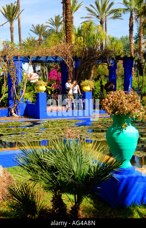 Morocco , Marrakesch , Majorelle Gardens , established by Yves Saint Laurent & Pierre Berge , romantic young lovers by pool Stock Photo