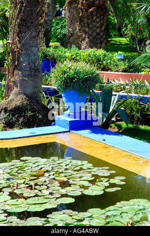 Morocco Marrakesch Majorelle Gardens , established by Yves Saint Laurent & Pierre Berge , lily pond with ornamental flower pots Stock Photo