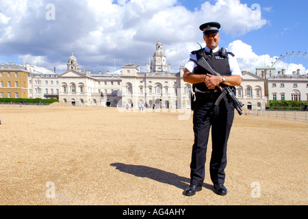 Armed British London Met or Metropolitan police officer in uniform at Horseguards Parade Ground Stock Photo