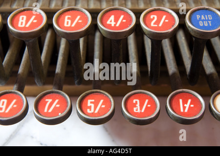 Old fashioned cash till showing shillings and pence on numbered keys Stock Photo
