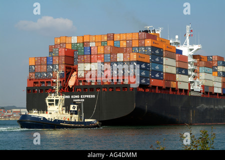 Tug Svitzer Sarah pulling Hong Kong Express a container ship operated by Hapag Lloyd from the quayside Southern England UK Stock Photo