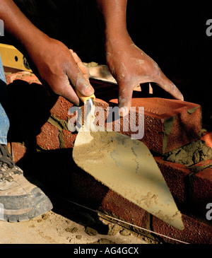 Man building a wall, with a trowel Stock Photo