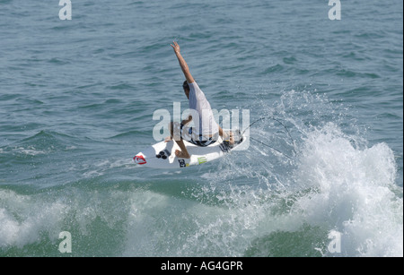 Pro surfer Dane Reynolds performing an aerial maneuver on waves in huntington beach California Stock Photo