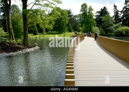 View of Sackler Crossing bridge over the lake Royal Botanic Gardens Kew Richmond Surrey England Britain UK Europe EU Stock Photo