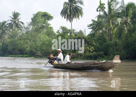 Two men on boat in Mekong delta waterway Stock Photo