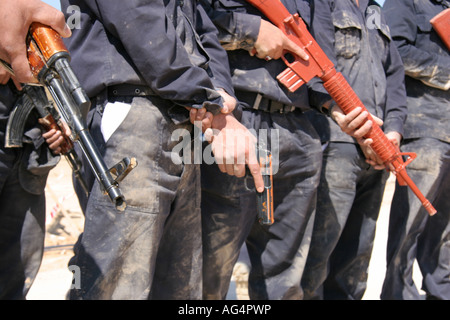 Iraqi police recruits holding weapons Stock Photo