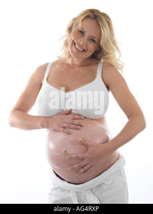 Pregnant Woman Applying Moisturiser Model Released Stock Photo