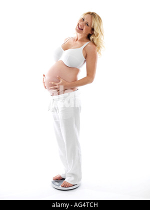 Pregnant Woman Using Weighing Scales Model Released Stock Photo