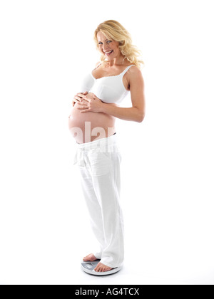 Pregnant Woman Using Weighing Scales Model Released Stock Photo