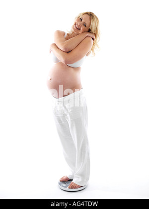 Pregnant Woman Using Weighing Scales Model Released Stock Photo