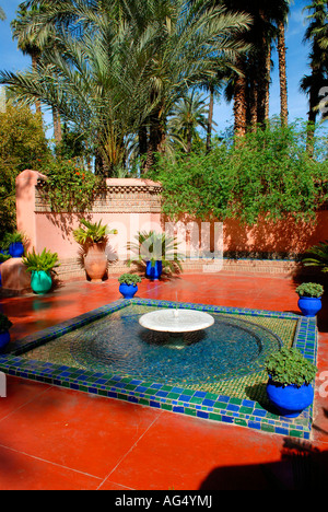 Morocco Marrakesch Majorelle Gardens , established by Yves Saint Laurent & Pierre Berge , ornamental pool with fountain in park Stock Photo