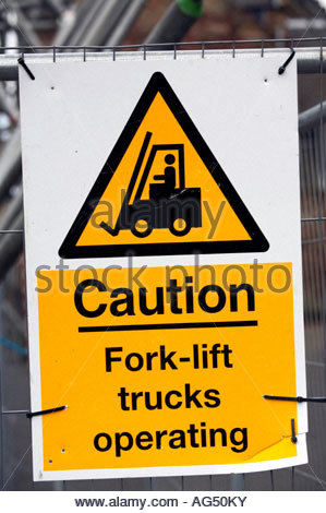 Caution fork lift trucks operating signpost Stock Photo