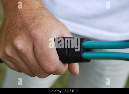 mature male hand holding tennis racket Stock Photo