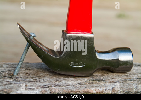 Claw hammer pulling large nail Stock Photo