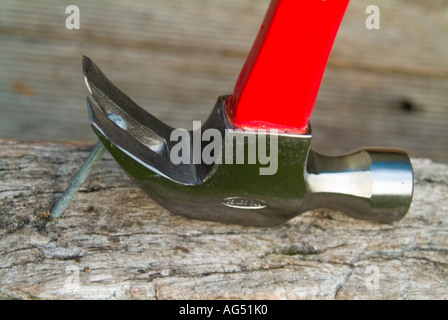 Claw hammer pulling large nail Stock Photo